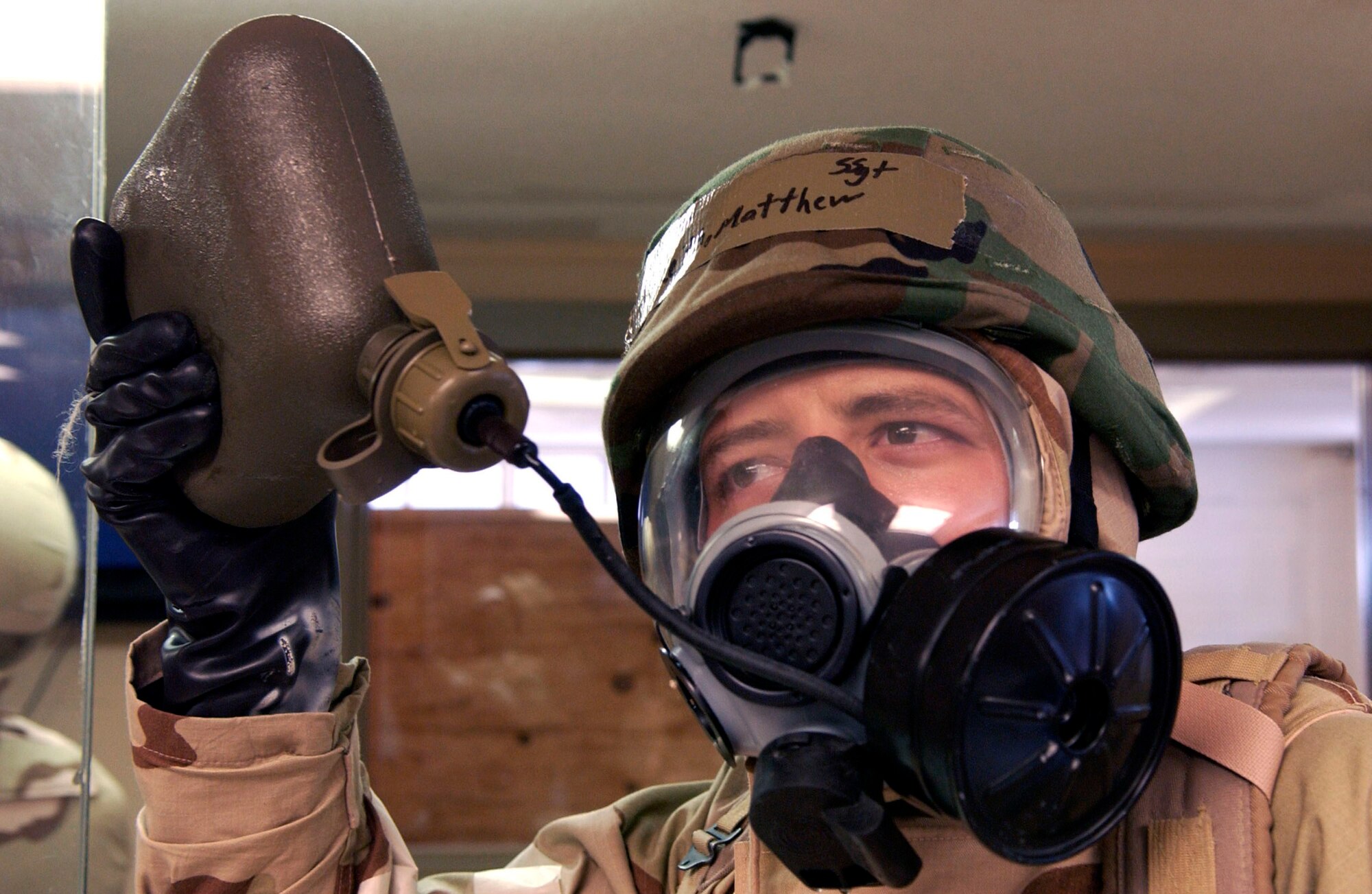 Staff Sgt. Matthew Keith, 6th Contracting Squadron, drinks water through his gas mask. MacDill servicemembers traveled to Gulfport, Miss., June 24, for a four-day ability to survive and operate training course in preparation for the upcoming Operational Readiness Inspection. (U.S. Air Force photo by Tech. Sgt. Sean White)