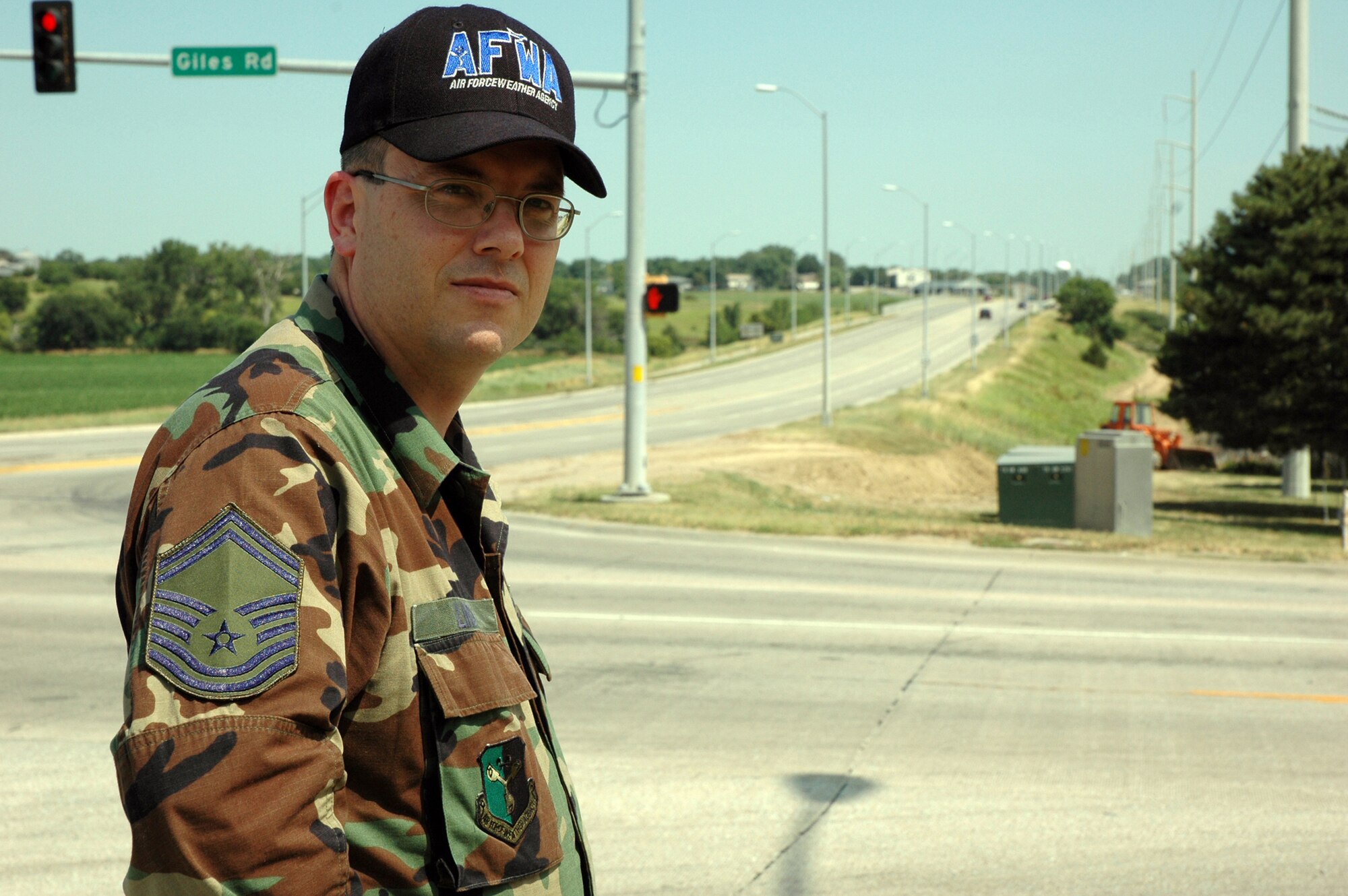 Senior Master Sergeant Clark Lind, with the Air Force Weather Agency at Offutt Air Force Base, Neb., stands on the corner of Highway 50 and Giles where the accident took place. Photo by G. A. Volb.