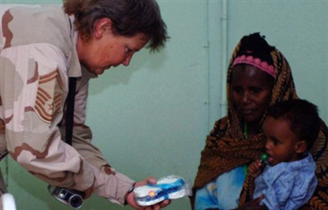 The new Africa Command will focus on humanitarian assistance, disaster relief and crisis response missions. Here, U.S. Air Force Senior Master Sgt. Dawn Fruits, 350th Civil Affairs Command Functional Specialty team, gives sandals to a child at Hospital Debalbala’s Nutrition Center in Djibouti, Africa. 
