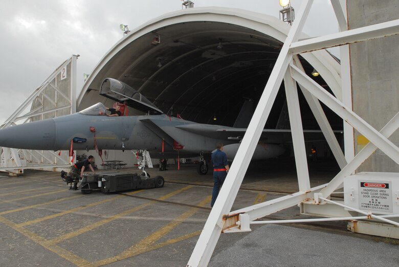 Airmen from the 18th Aircraft Maintenance Squadron tow an F-15C Eagle into a protective aircraft shelter at Kadena Air Base, Japan, July 12, 2007 in preparation for Typhoon Man-Yi which is expected to hit Okinawa Friday. It is the first typhoon of the year for the island.  U.S. Air Force/Airman 1st Class Kasey Zickmund