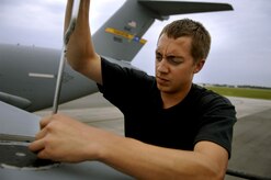 Senior Airman Shawn Summers, crew chief in the 315th Aircraft Maintenance Squadron, works on an in-trail light behind engine one on a C-17 Globemaster III on the Charleston Air Force Base, S.C., flightline July 2, 2007. (U.S. Air Force Photo/Airman 1st Class Nicholas Pilch)