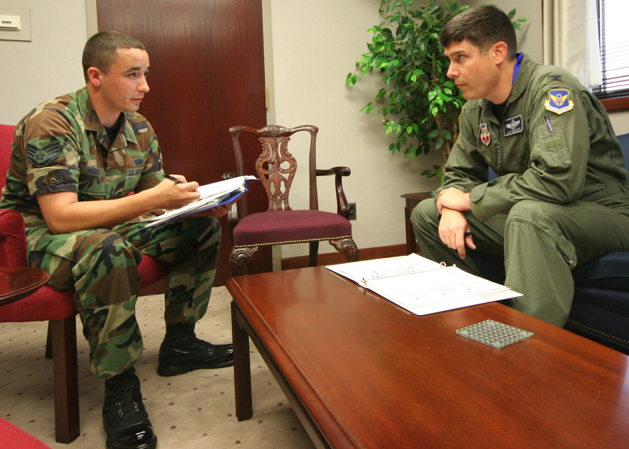 Staff Sgt. Chris Hobbs, 509th Mission Support Squadron, and Col. John Robinson, 509th Bomb Wing vice commander, discuss the colonel’s personnel reliability program initial training July 11. (U.S. Air Force Photo/Airman 1st Class Stephen Linch)