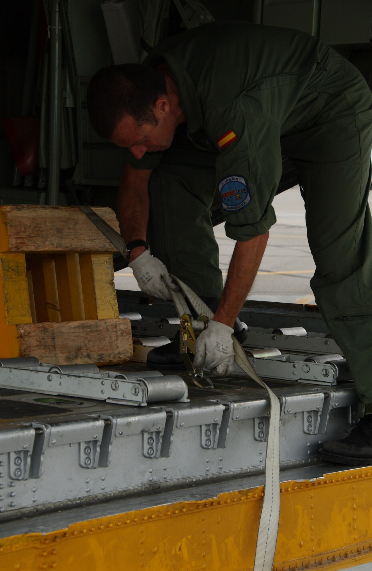 EIELSON AIR FORCE BASE, Alaska -- A member of the Spanish Air Force, Zaragoza Air Base, reconnects straps in place after unloading cargo upon arriving to Eielson AFB, AK. July 10, 2007. Red Flag-Alaska, a series of Pacific Air Forces commander-directed field training exercises for U.S. forces, provides joint offensive counter-air, interdiction, close air support, and large force employment training in a simulated combat environment. (U.S. Air Force photo by Airman 1st Class Christopher Griffin) 