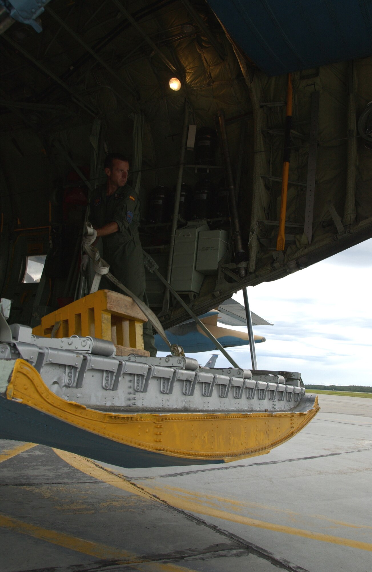 EIELSON AIR FORCE BASE, Alaska -- A member of the Spanish Air Force, Zaragoza Air Base, reconnects straps in place after unloading cargo upon arriving to Eielson AFB, AK. July 10, 2007. Red Flag-Alaska, a series of Pacific Air Forces commander-directed field training exercises for U.S. forces, provides joint offensive counter-air, interdiction, close air support, and large force employment training in a simulated combat environment. (U.S. Air Force photo by Airman 1st Class Christopher Griffin) 