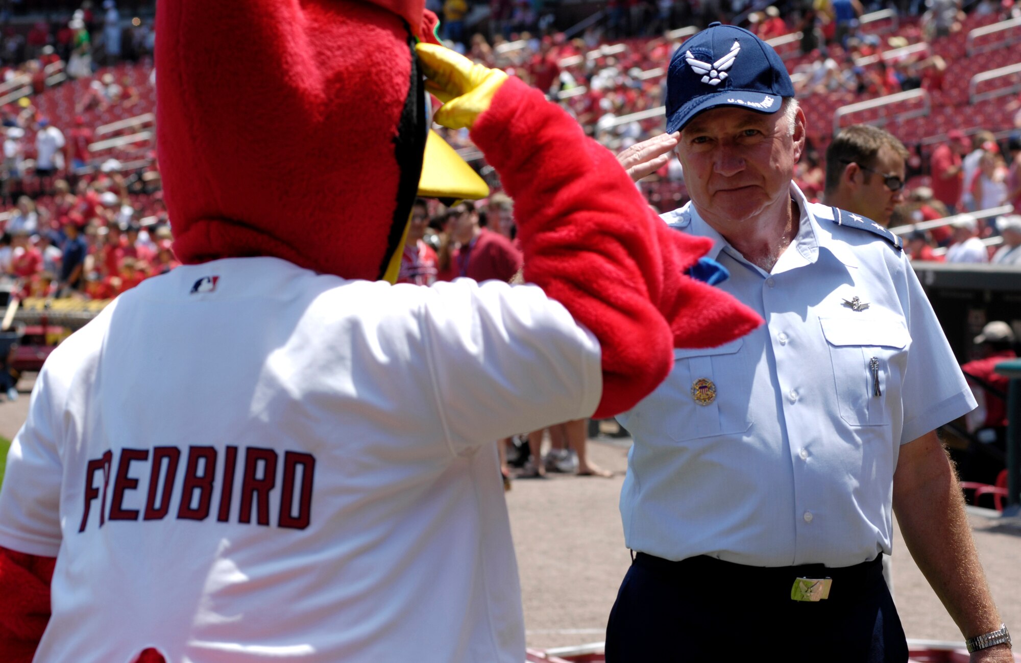 Maj. Gen. Thomas F. Deppe salutes Fredbird, the St. Louis Cardinals mascot, at Busch Stadium in St. Louis July 8.  The general threw out the first pitch prior to the Cardinals-Giants game as part of the Air Force Week St. Louis festivities.  General Deppe is the 20th Air Force commander at F.E. Warren Air Force Base, Wyo.  (U.S. Air Force photo/Staff Sgt. Brian Ferguson)
