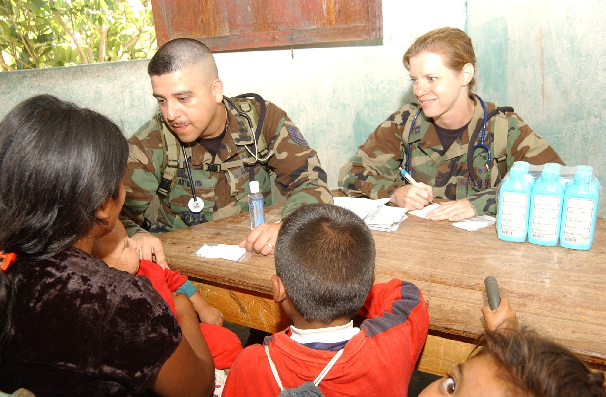 EL HORNO, Honduras - Capt. Kimberly Evans, Medical Element at Soto Cano Air Base, Honduras, listens to a patient's medical history with the help of Tech. Sgt. Jesus Antillon, who translated for her during a Medical Readiness Training Exercise June 29, 2007. (U.S. Air Force photo/Tech. Sgt. Sonny Cohrs)