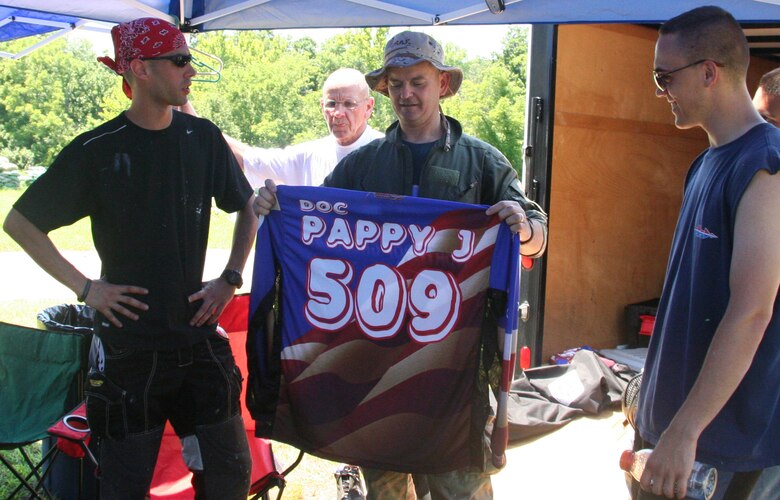 WHITEMAN AIR FORCE BASE, Mo. -- Staff Sgts. Ben Simmons (left), and Brad Dugan (right), 509th Aircraft Maintenance Squadron, present Lt. Col. Jeffrey Johnson, 509th Medical Operations Squadron commander, with a paintball jersey July 7 at the “Doc Pappy J” Hooah Lock-and-Load Paintball Tournament at Area 509. The jersey is made in the same style and color as the Northrop-Grumman team, which won the tournament, with “Doc Pappy J” and the number 509 on the back. The 7-man team tournament was held in honor of Colonel Johnson’s involvement and contributions to bringing a paintball field, Area 509, to Whiteman. Colonel Johnson will move on to the Air Force Academy in Colorado Springs, Colo. His last day at Whiteman is July 23. (U.S. Air Force photo/Staff Sgt. Jason Barebo)