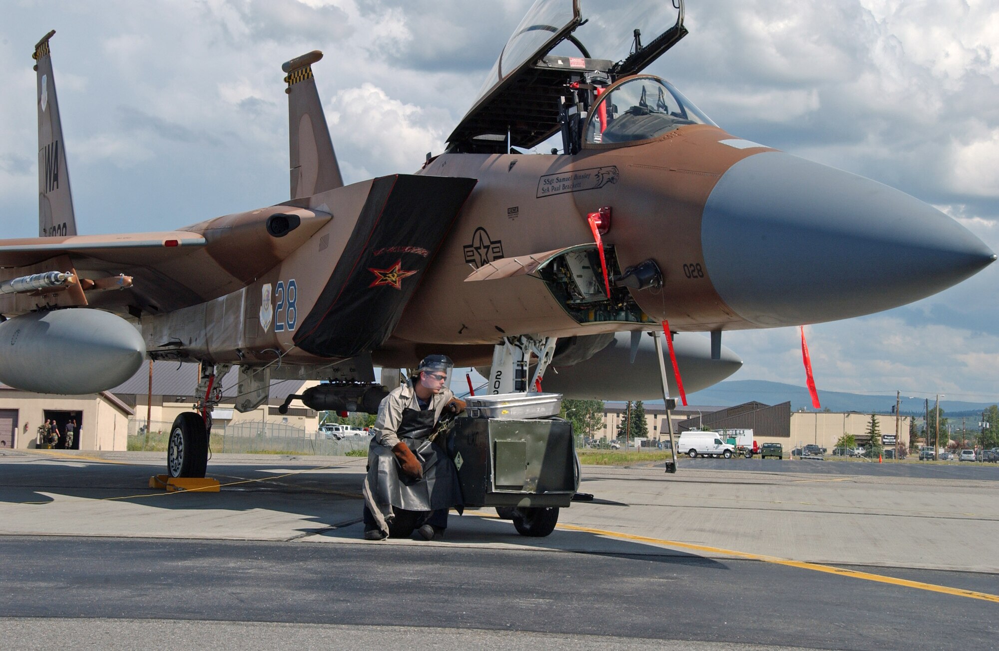 Airman 1st Class Zachary Garretson services the liquid oxygen system on an F-15 Eagle July 9 on the Eielson Air Force Base, Alaska, flightline. The aircraft, from the 65th Aggressor Squadron at Nellis AFB, Nev., is at Eielson AFB to take part in Red Flag-Alaska 07-3, a multi-service, multi-platform coordinated, combat operations exercise, which runs through the July 27.  Airman Garretson is a maintainer with the 57th Aircraft Maintenance Squadron at Nellis AFB.  (U.S. Air Force photo/Airman 1st Class Christopher Griffin)