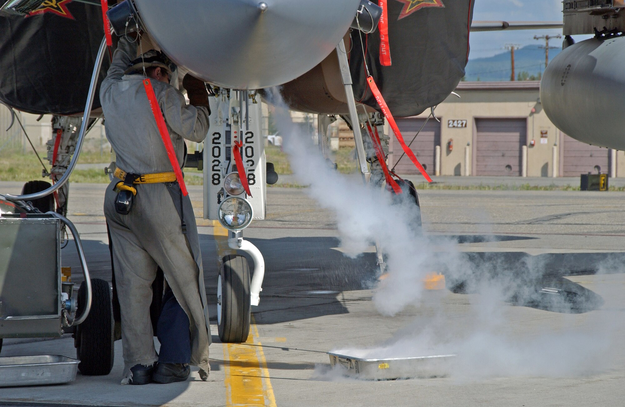 Airman 1st Class Zachary Garretson services the liquid oxygen system on an F-15 Eagle July 9 on the Eielson Air Force Base, Alaska, flightline. The aircraft, from the 65th Aggressor Squadron at Nellis AFB, Nev., is at Eielson AFB to take part in Red Flag-Alaska 07-3, a multi-service, multi-platform coordinated, combat operations exercise, which runs through the July 27.  Airman Garretson is a maintainer with the 57th Aircraft Maintenance Squadron at Nellis AFB.  (U.S. Air Force photo/Airman 1st Class Christopher Griffin)