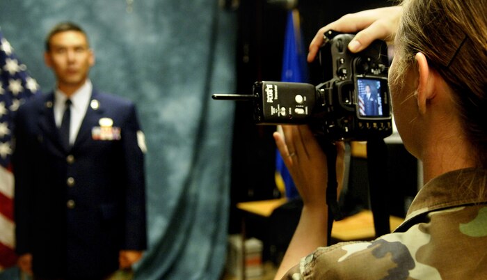 Airman 1st Class Cassandra Vriesman, 437th Airlift Wing Public Affairs broadcaster, takes a studio portrait of Tech. Sgt. Buddy King, 437th Maintenance Squadron avionics production supervisor.  (U.S. Air Force Photo/Airman 1st Class Nicholas Pilch)