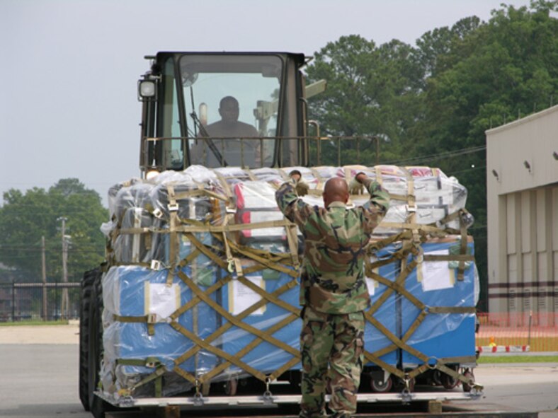 Staff Sgt. Jevon Fulton drives a palletized forklift while Staff Sgt. Lenwood Spells serves as the spotter helping to direct Sgt. Fulton. Both Airman are members of the 916th Logistics Readiness Squadron at Seymour Johnson Air Force Base. The Airman were palletizing and moving cargo during a maintance mobility exercise during the wing's June unit training assembly. The exercise prepared the wing for a real deployment to Turkey in July.