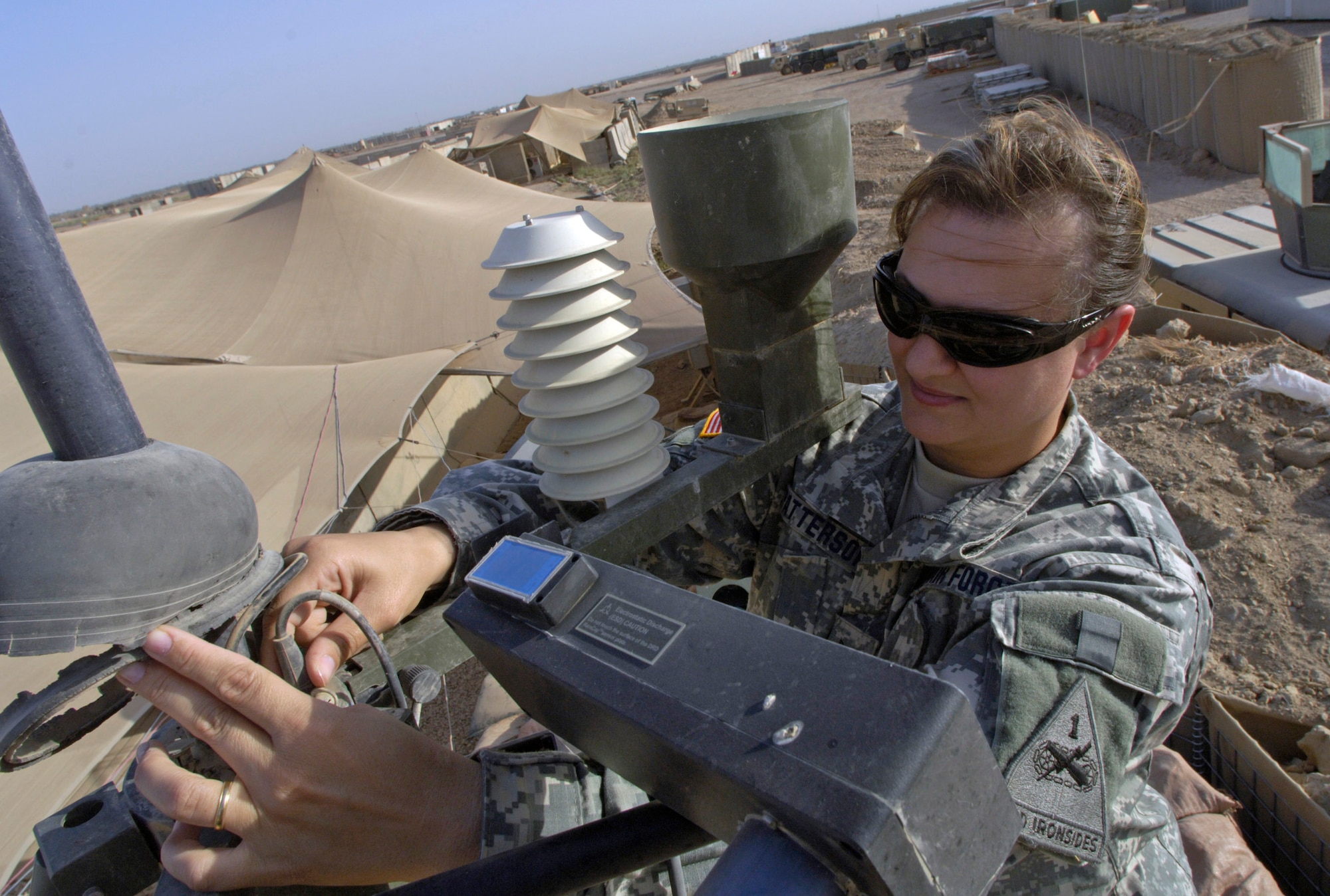 Tech. Sgt. Andrea Patterson performs her daily maintenance routine on a tactical meteorological operating system June 23 at Forward Operating Base Kalsu, Iraq. Sergeant Patterson and two other Air Force weather forecasters provide 24-hour-a-day weather updates to the Army 3rd Infantry Division's operations occurring in the Triangle of Death area. The instantaneous weather information the battlefield weathermen are able to provide are critical to the success, and to the safety of the 3rd ID's ground and aviation operations. Though Sergeant Patterson is attached to the 3rd ID, she officially falls under the recently formed 3rd Expeditionary Weather Squadron headquartered on Camp Victory in Iraq. She is deployed from Detachment 6 of the 7th Weather Squadron from Wiesbaden, Germany. (U.S. Air Force photo/Master Sgt. Jim Varhegyi) 
