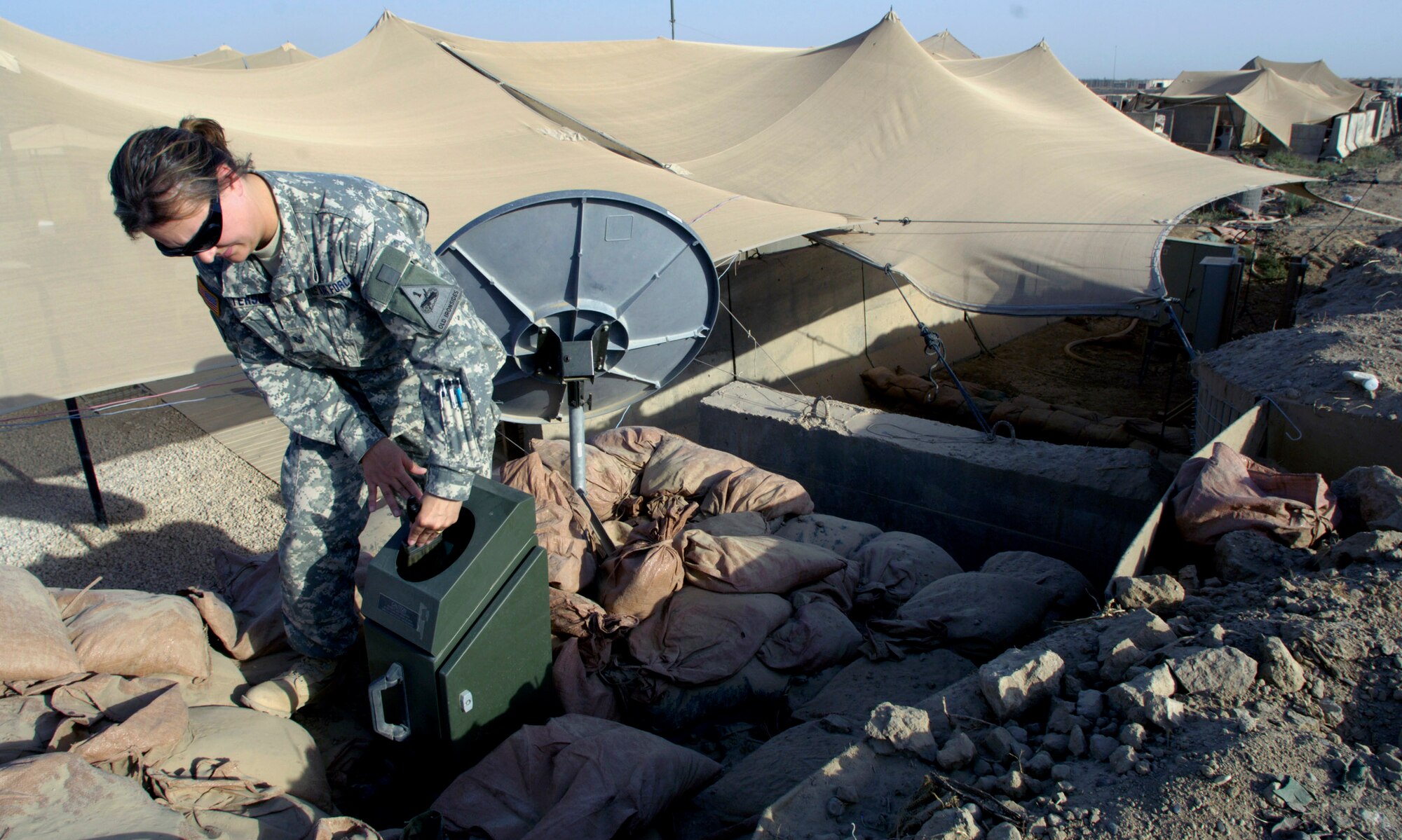 Tech. Sgt. Andrea Patterson performs her daily maintenance routine on a tactical meteorological operating system June 23 at Forward Operating Base Kalsu, Iraq. Sergeant Patterson and two other Air Force weather forecasters provide 24-hour-a-day weather updates to the Army 3rd Infantry Division's operations occurring in the Triangle of Death area. The instantaneous weather information the battlefield weathermen are able to provide are critical to the success, and to the safety of the 3rd ID's ground and aviation operations. Though Sergeant Patterson is attached to the 3rd ID, she officially falls under the recently formed 3rd Expeditionary Weather Squadron headquartered on Camp Victory in Iraq. She is deployed from Detachment 6 of the 7th Weather Squadron from Wiesbaden, Germany. (U.S. Air Force photo/Master Sgt. Jim Varhegyi) 
