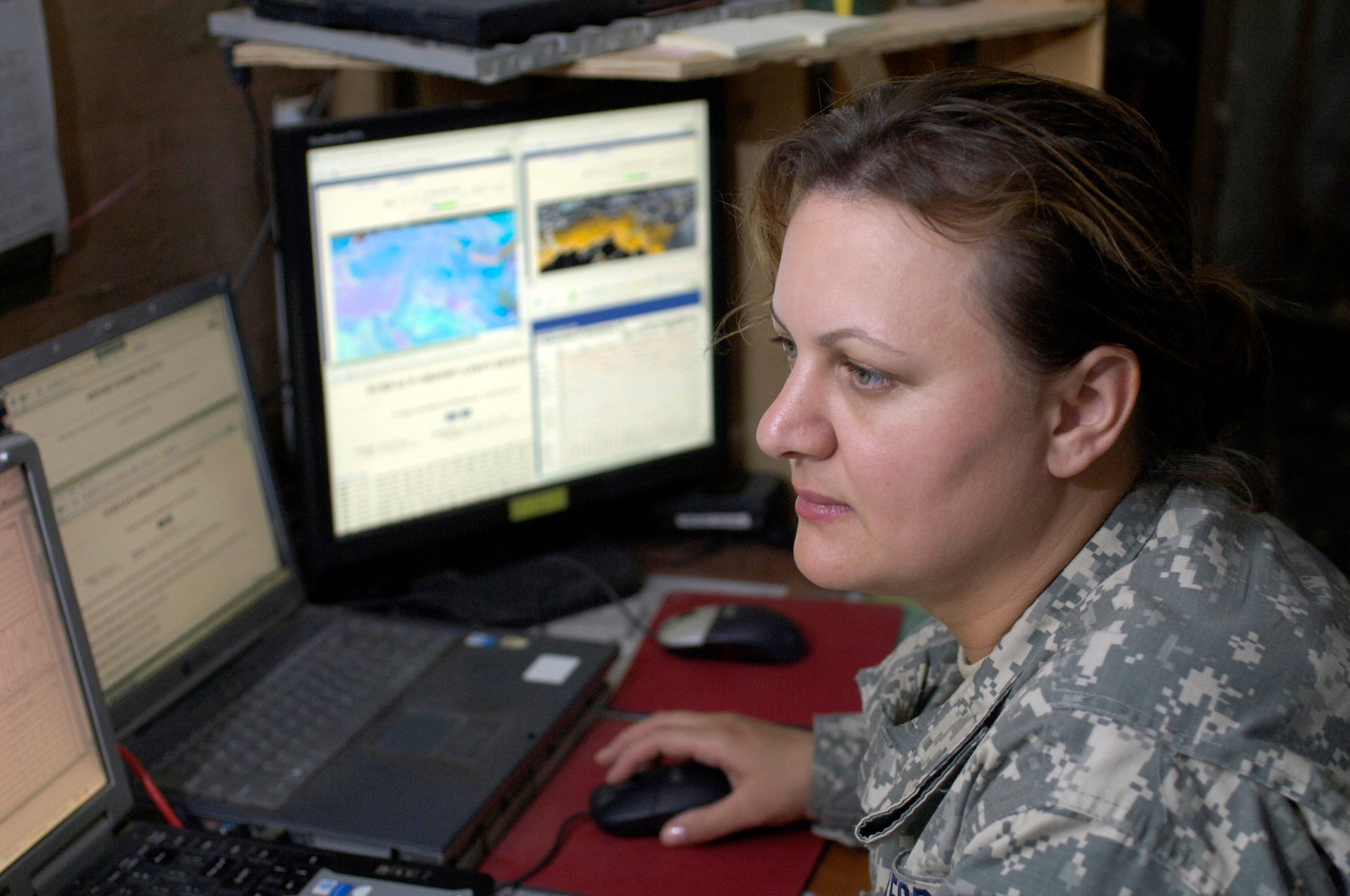 Tech. Sgt. Andrea Patterson monitors multiple weather tracking systems in the 2nd Battalion, 3rd Combat aviation Brigade, 3rd Infantry Division, tactical operations center June 23 at Forward Operating Base Kalsu, Iraq. Sergeant Patterson and two other Air Force weather forecasters provide 24-hour-a-day weather updates to the Army 3rd Infantry Division's operations occurring in the Triangle of Death area. The instantaneous weather information the battlefield weathermen are able to provide are critical to the success, and to the safety of the 3rd ID's ground and aviation operations. Though Sergeant Patterson is attached to the 3rd ID, she officially falls under the recently formed 3rd Expeditionary Weather Squadron headquartered on Camp Victory in Iraq. She is deployed from Detachment 6 of the 7th Weather Squadron from Wiesbaden, Germany. (U.S. Air Force photo/Master Sgt. Jim Varhegyi) 