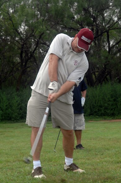 DYESS AIR FORCE BASE, Texas -- Tech. Sgt. Daniel Siratt, 7th Communications Squadron, takes an approach shot into the 10th green at the Air Force Ball fund raiser at the Mesquite Grove Golf Course June 6. The tournament raised almost $1,100 for this year's 60th Anniversary ball. (U.S. Air Force photo by Senior Airman Alan Garrison)