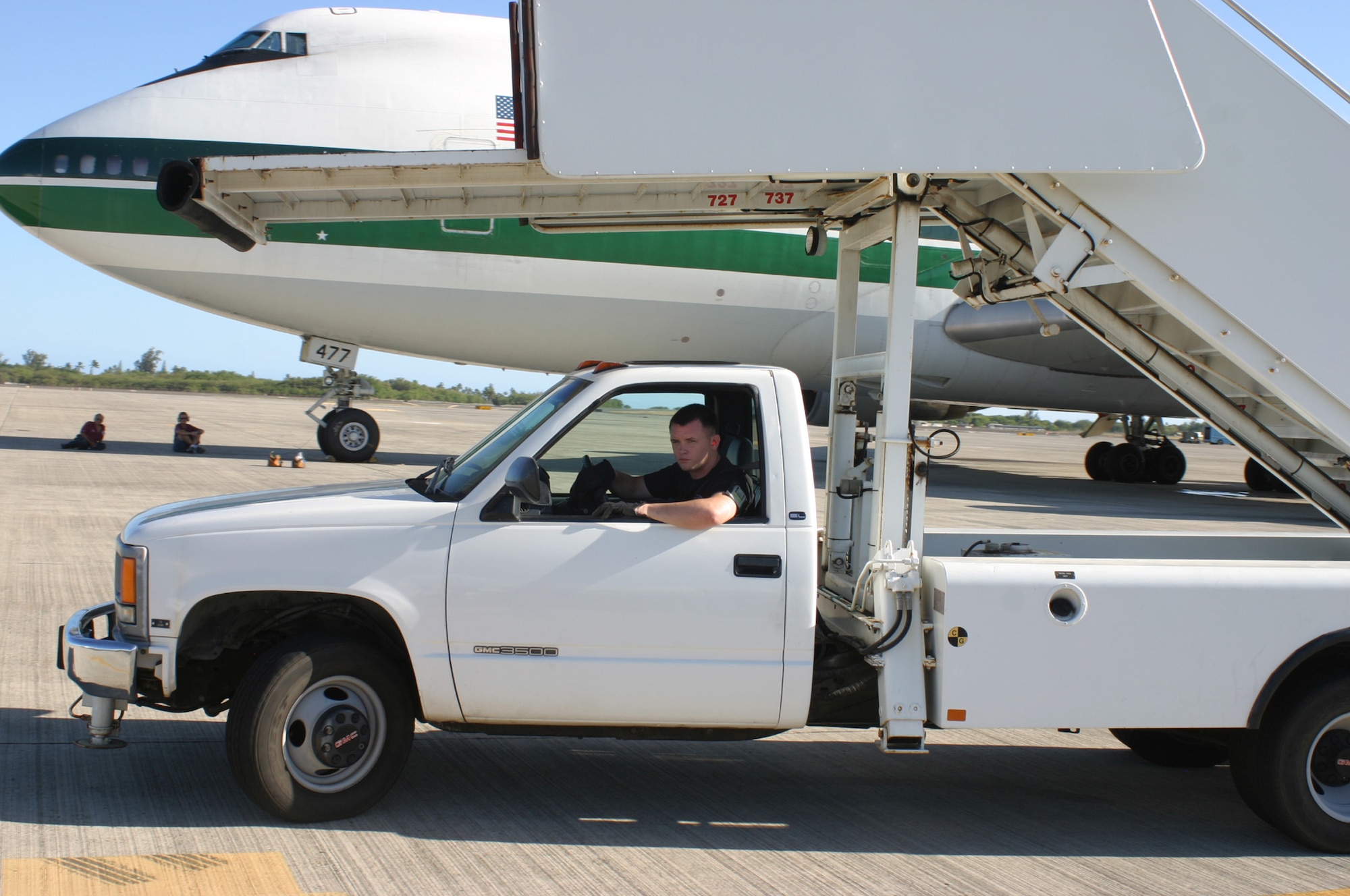 HICKAM AFB, Hawaii - Senior Airman Bryan Reed works in ramp services with the 87th Aerial Port Squadron deployed from Wright-Patterson AFB, Ohio to move a stair truck away from an Evergreen International 747 aircraft. (U.S. Air Force photo/Master Sgt. Doug Moore)