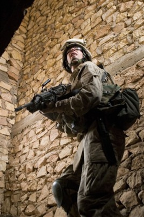 U.S. Marine Corps Lance Cpl. Daniel Dalton clears the second floor of a building in Ar Rutbah, Iraq, on May 10, 2007.  Marines are conducting security patrols to disrupt insurgent capabilities to communicate.  Dalton is assigned to 2nd Squad, 2nd Platoon, Alpha Company, 1st Battalion, 2nd Marine Regiment.  