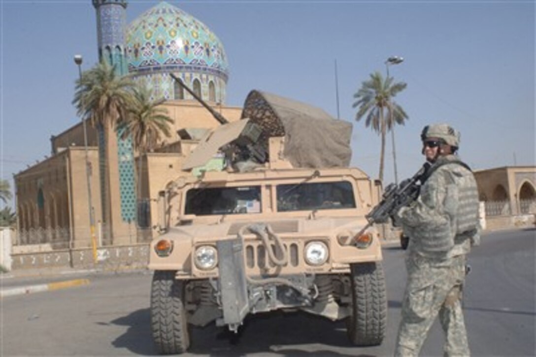 U.S. Army Sgt. Christopher Burke provides security during a patrol in the Rusafa area of Baghdad, Iraq, on June 16, 2007.  Burke is assigned to Charlie Company, 2nd Battalion, 69th Armor Regiment, 3rd Brigade Combat Team, 3rd Infantry Division.  