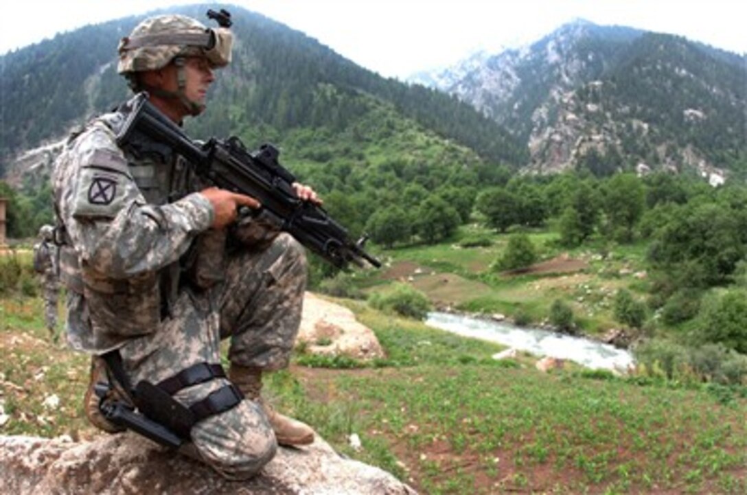 U.S. Army Spc. Jason Curtis provides security for members of a medical civil action project in Parun, Afghanistan, on June 28, 2007.  Curtis is assigned to Charlie Company, 1st Battalion, 151st Infantry Regiment.  