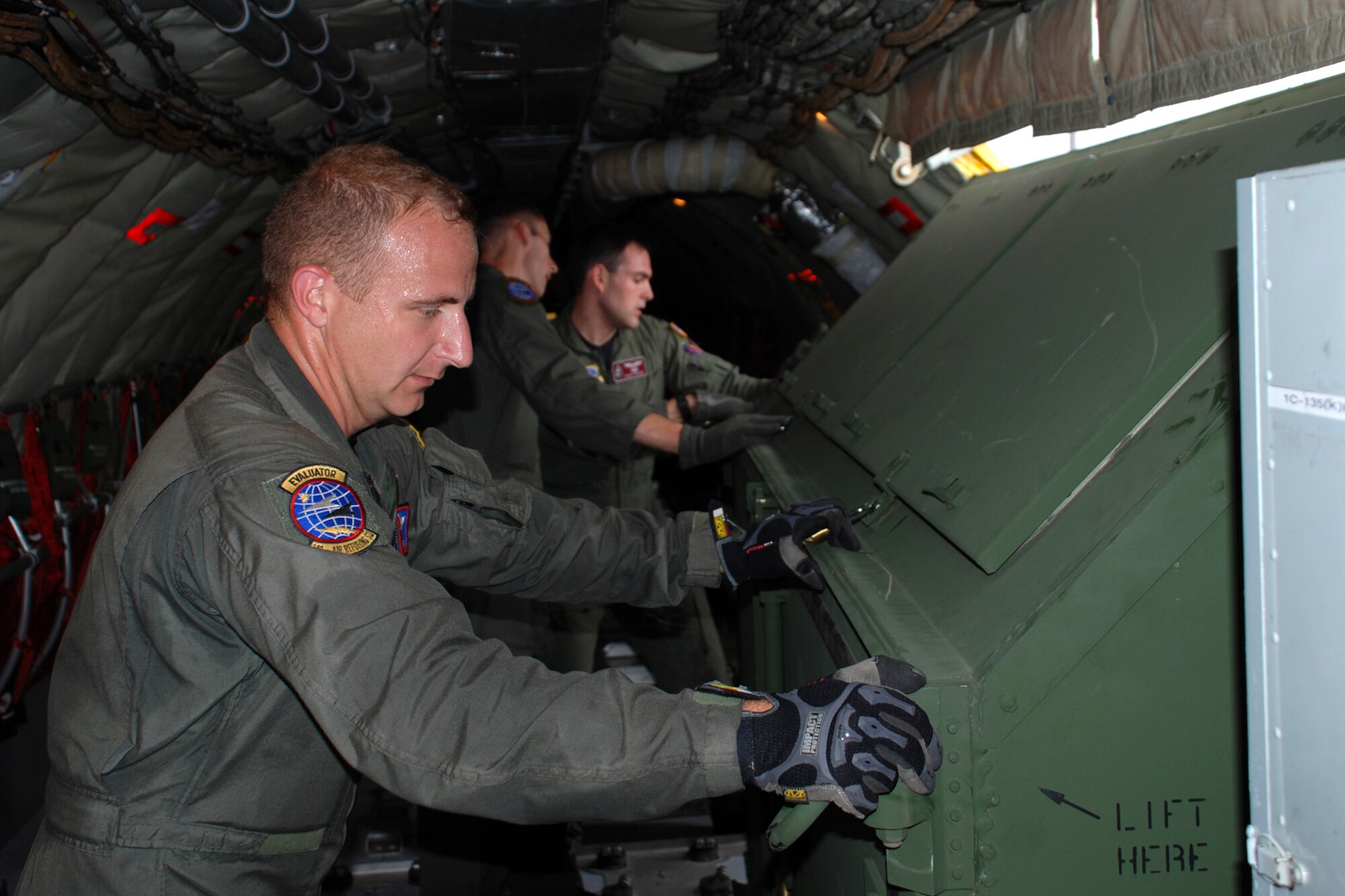Rodeo aircrew member Tech. Sergeant, Fred Ramey, 349 Air Refueling Squadron, helps guide cargo on a KC- 135 Stratotanker during a loading drill that helps the team prepare for a tanker loading/unloading event at the Air Mobility Command’s Rodeo competition July 21-28 at McCord Air Force Base, Wash. (Photo by Airman 1st Class Jessica Lockoski)