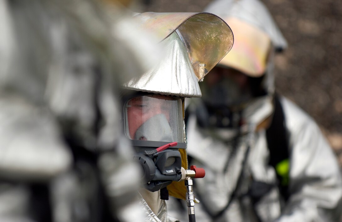 Firefighters from the 36th Civil Engineer Squadron, prepare to respond to a structural fire scenario during an exercise July 10 here. The 36 CES participated in a week-long exercise to test member's ability to deploy, as well as respond to real-world scenarios. (U.S. Air Force photo by Senior Airman Miranda Moorer) 