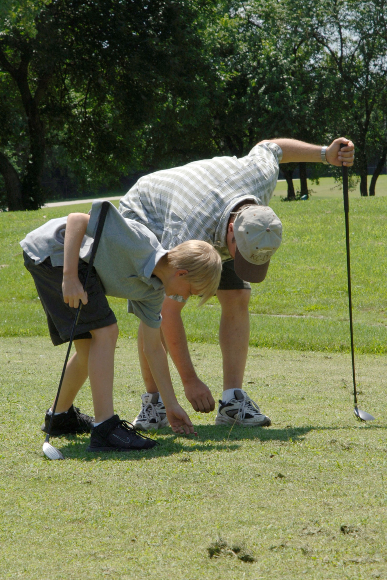 MCCONNELL AIR FORCE BASE, Kan. -- Lt. Col. Troy Davis, 349th Air Refueling Squadron, shows his son Cameron how to tee-off at the Rodeo golf tournament here July 6. Lt. Col. Davis is McConnell’s Rodeo team chief and will be representing McConnell with fellow team members when they compete at McCord Air Force Base, Wash. July 21-28. (Photo by Airman 1st Class Roy Lynch)