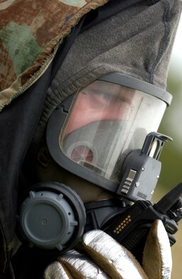 Airman 1st Class Joshua Mackie, a firefighter from the 36th Civil Engineer Squadron, responds to a structural fire scenario during an exercise, July 10 here. The 36 CES participated in a week-long exercise to test member's ability to deploy, as well as respond to real-world scenarios. (U.S. Air Force photo by Senior Airman Miranda Moorer)                