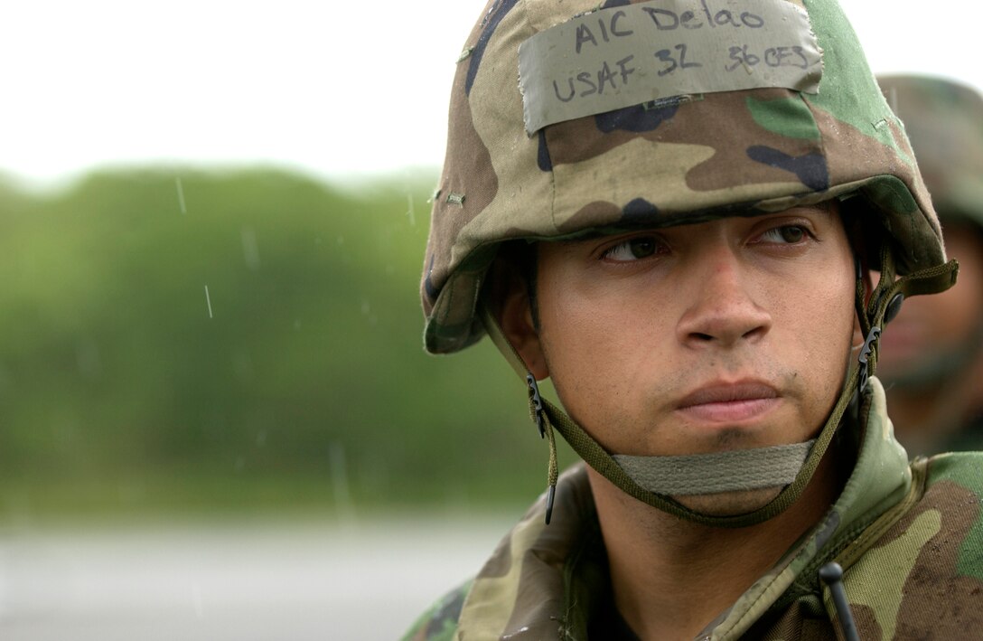 Airman 1st Class Aaron Delao, 36th Civil Engineer Squadron waits in the rain at Northwest Field during an exercise held by the 36 CES, July 10.  The 36 CES participated in a week-long exercise to test member's ability to deploy, as well as respond to real-world scenarios. (U.S. Air Force photo by Senior Airman Miranda Moorer)