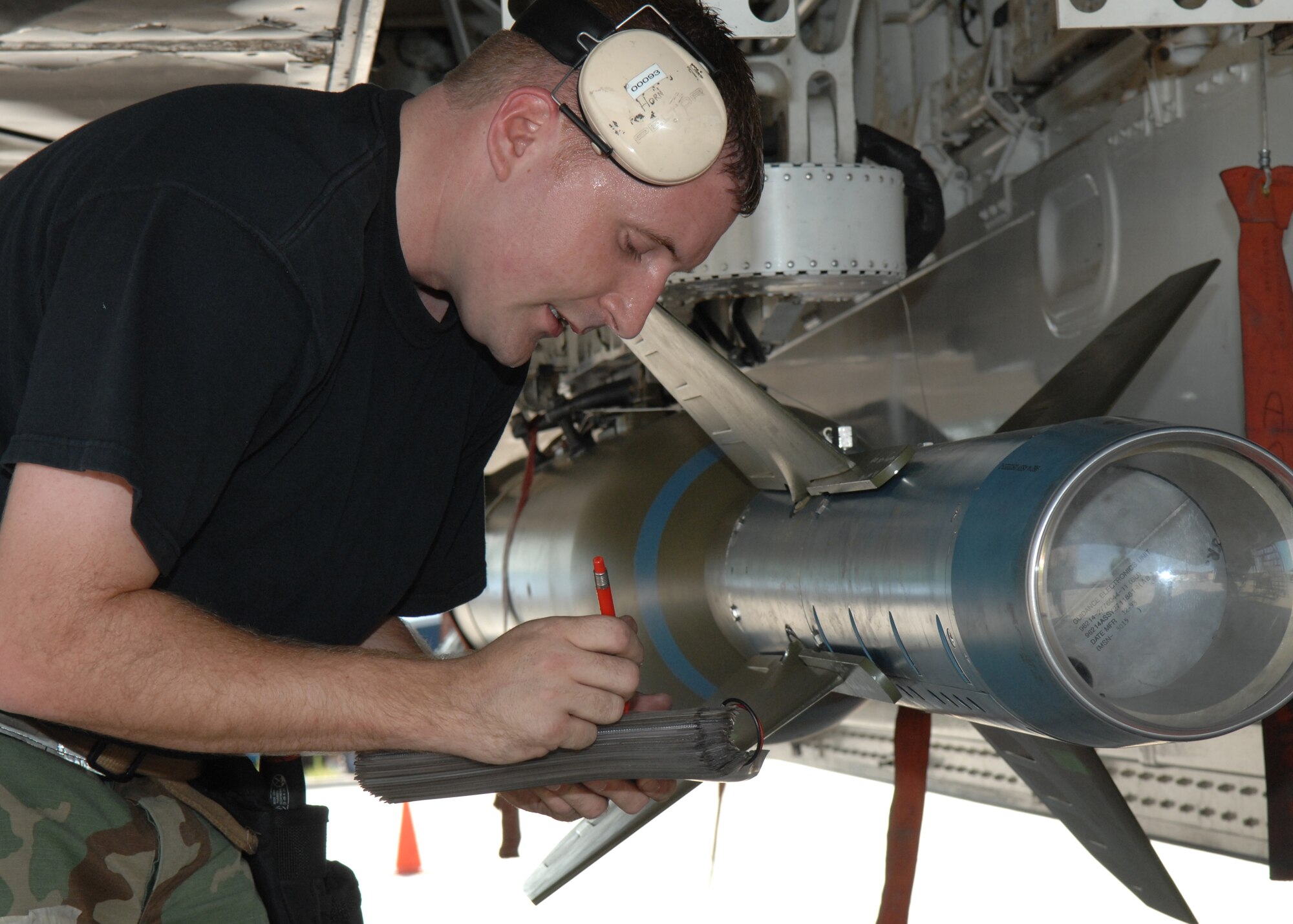 Staff Sgt. Christopher Osterholm, 9the Aircraft Maintenance Unit weapons load crew member, posterloads the Guided Control Unit (GCU) seeker head in order to complete the bomb load on an F-117A, (U.S. Air Force photo by Senior Airman Anthony Nelson Jr.)
