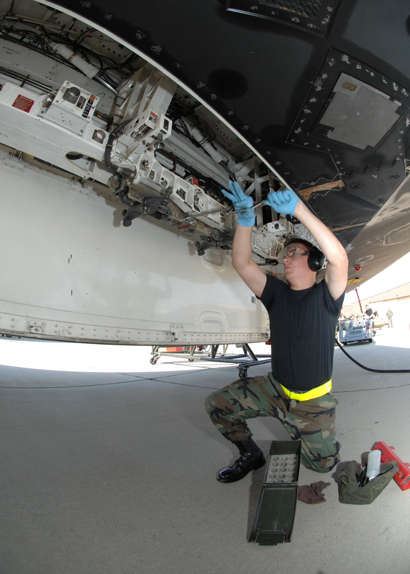 Airman 1st Class Corey Carlson, 9th Aircraft Maintenance Unit weapons load crew member, tightens a bolt on a nF-117A during the Weapons Standardization Load Crew of the Quarter Competition. (U.S. Air Force photo by Senior Airman Anthony Nelson Jr.)
