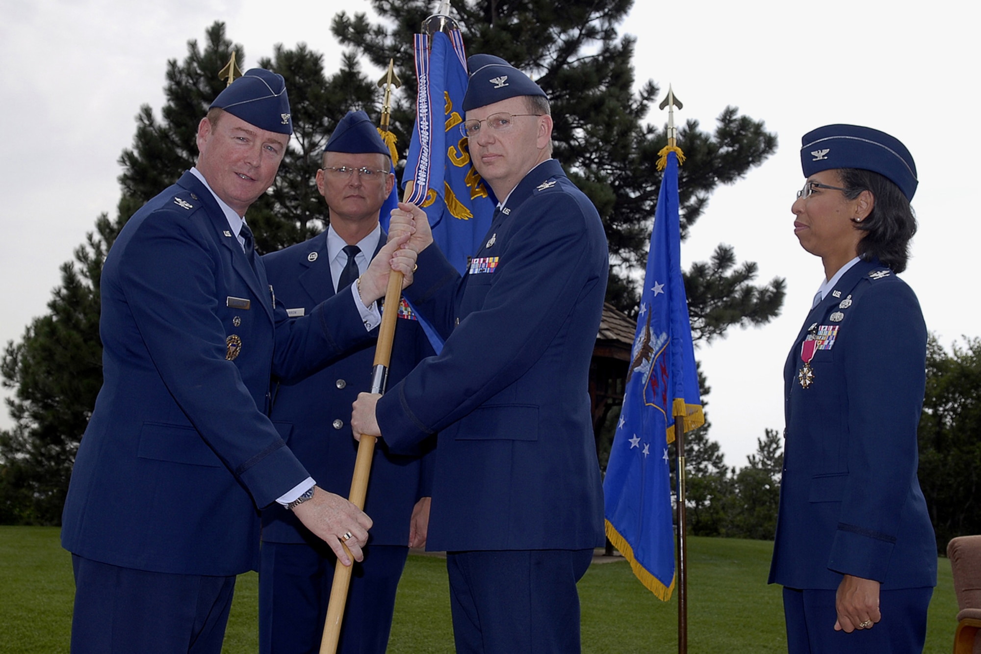 Col. Scott Shepherd (left), 21st Space Wing vice commander, passes the 721st Mission Support Group flag to incoming commander Col. Bradford Gentry during the 721st MSG change of command ceremony July 12. Colonel Gentry most recently served as the Defense Systems Agency Field Office commander, supporting U.S. Joint Forces Command, Air Combat Command, and U.S. Army Forces Command.
Also pictured are outgoing commander Col. Joyce Jenkins-Harden, who is retiring, and Chief Master Sgt. Joseph Barron, 721st MSG chief. (U.S. Air Force photo by Rob L. Bussard)
