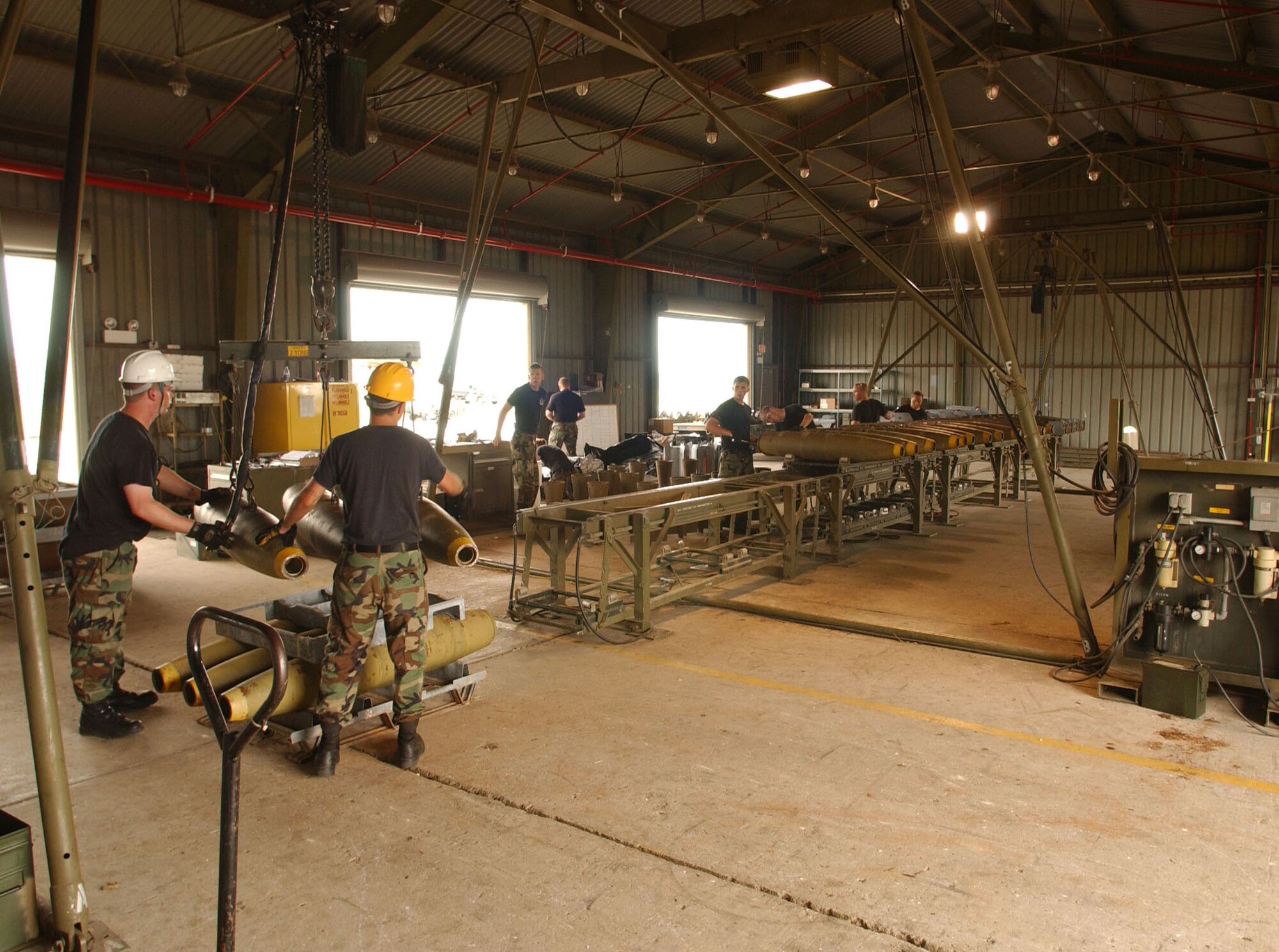 Airmen participating in a combat ammunition production exercise being held at Kunsan Air Base, South Korea, assemble, pack and load bombs for shipment July 11.  The three-day exercise provides Pacific Air Forces and Air Combat Command units with training in mass munitions assembly in support of aircraft sortie generation.  (U.S. Air Force photo/Senior Steven R. Doty)
