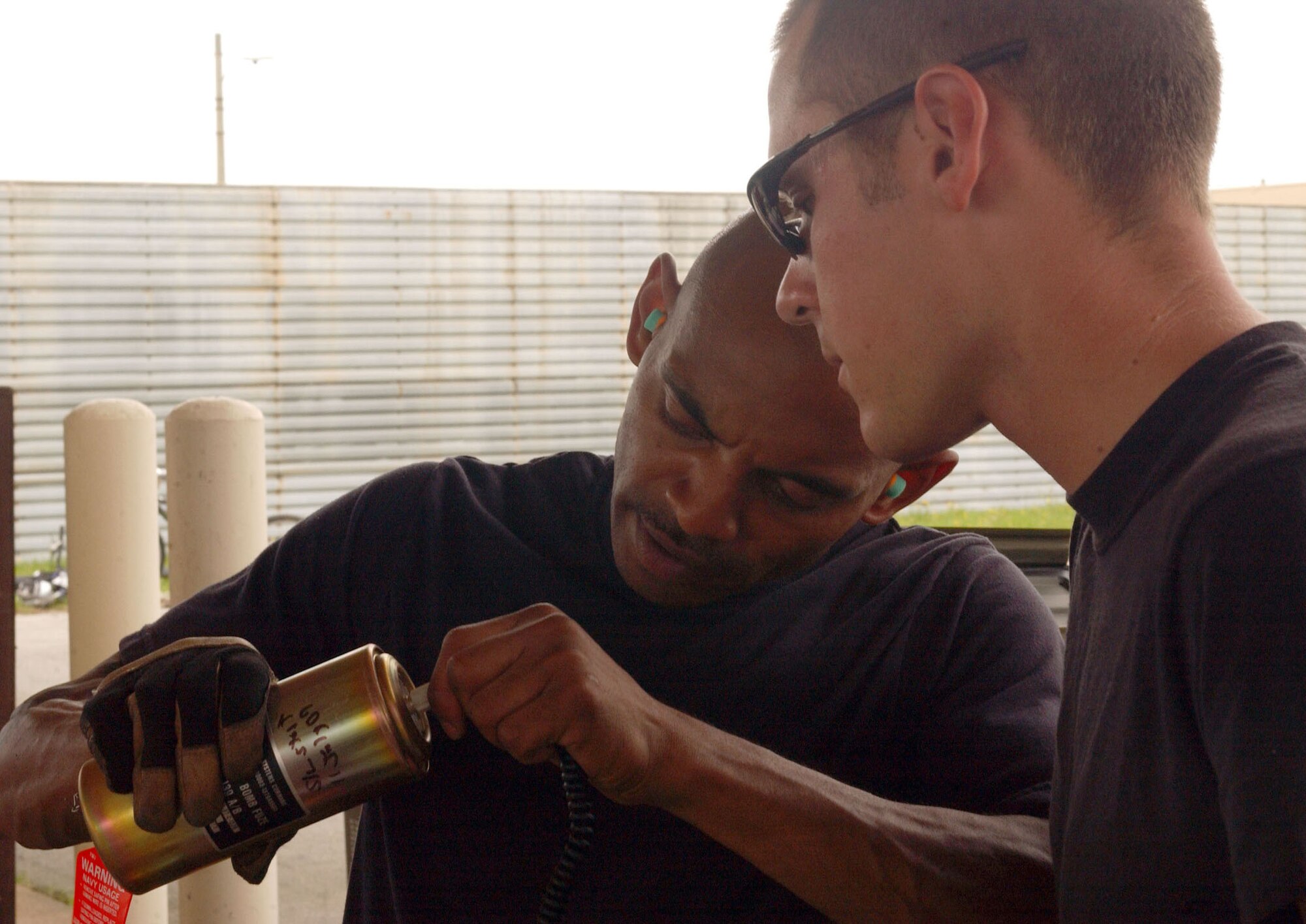 Staff Sgt. Robert Thomas (left) shows Airman 1st Class Kale Wenzel how to assemble a fuse July 11 during a combat ammunition production exercise being held at Kunsan Air Base, South Korea.  The three-day exercise provides Pacific Air Forces and Air Combat Command units with training in mass munitions assembly in support of aircraft sortie generation.  Sergeant Thomas is from the 31st Maintenance Squadron at Aviano AB, Italy, and Airman Wenzel is from the 8th MXS at Kunsan AB.  (U.S. Air Force photo/Senior Steven R. Doty)