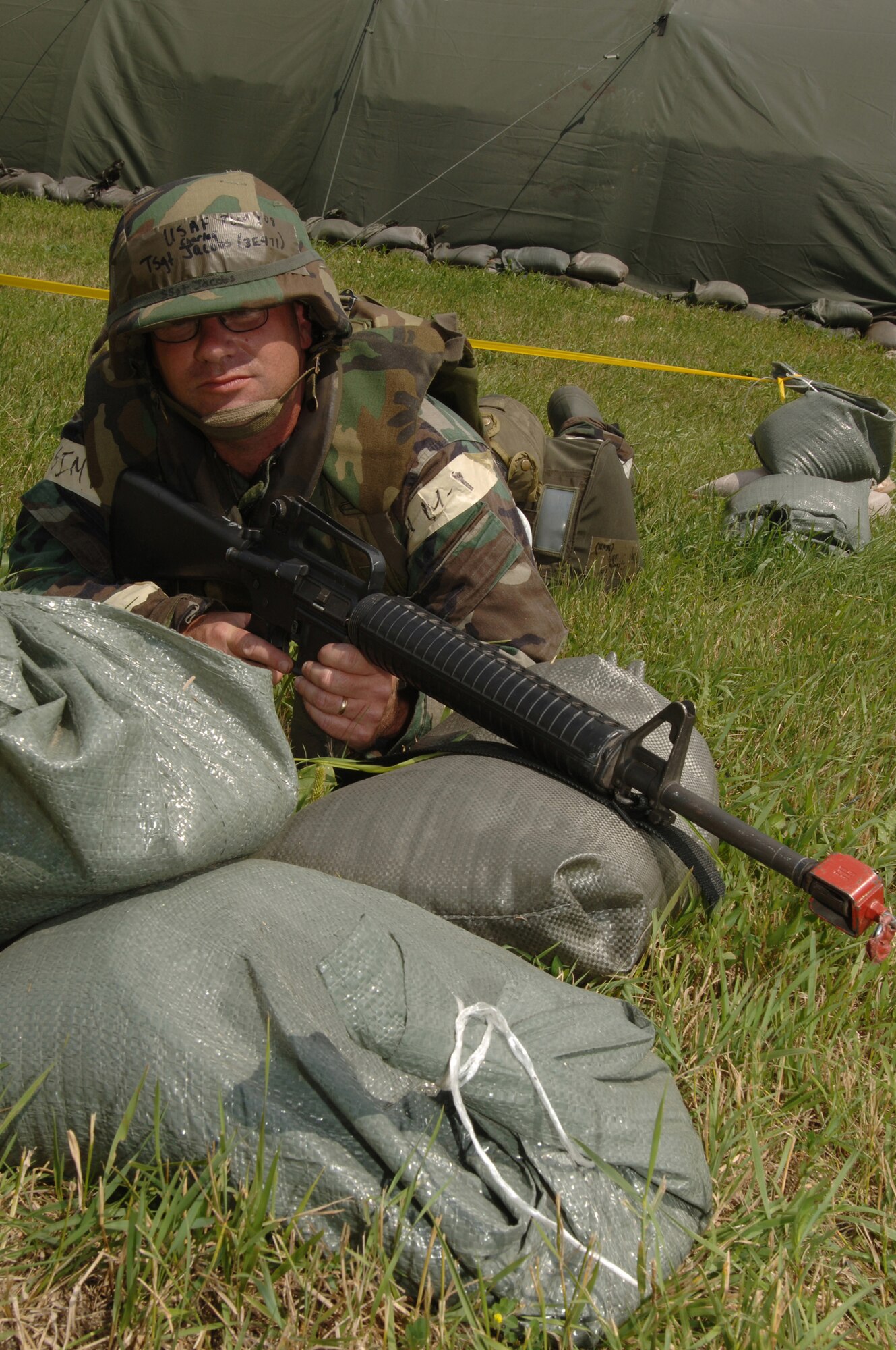 MINOT AIR FORCE BASE, N.D. – Tech. Sgt. Charles Jacobs, 5th Civil Engineer Squadron, takes a defensive fighting position and waits for a simulated mortar attack during a Phase II exercise. Phase II exercises evaluate Airmen's ability to operate and survive in deployed locations. (U.S. Air Force Photo by Senior Airman Stacy Moless)
