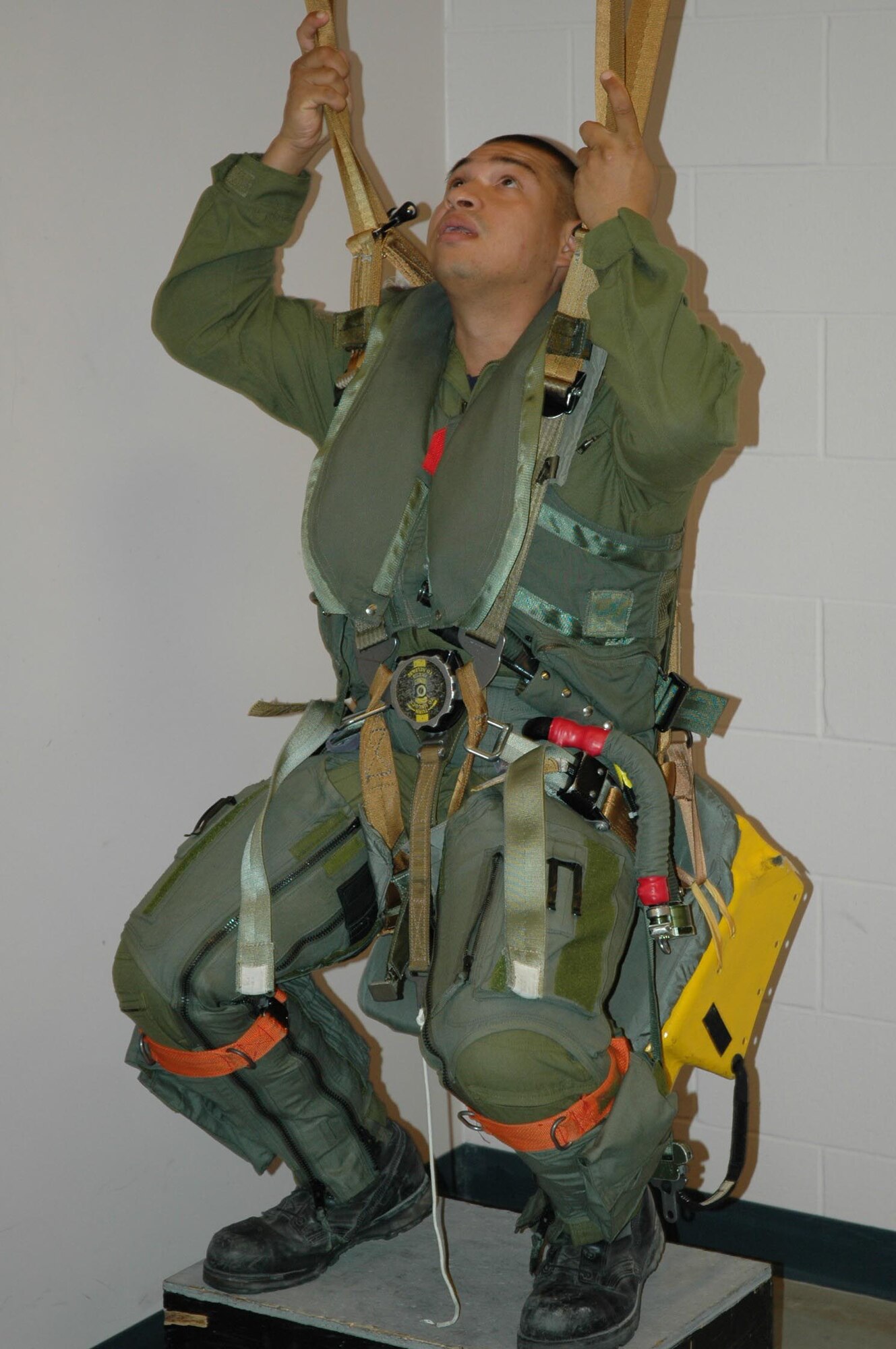 Senior Airman Luna checks his parachute lines during egress training.  (USAF photo/Senior Master Sgt. Marcus Falleaf)