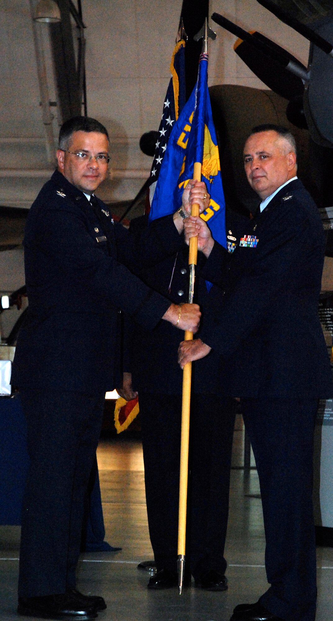 Col. Walton F. Reddish accepts the 512th Aersopace Medicine Squadron guidon from Col. Randal L. Bright, 512th Airlift Wing commander in a dual change of command, retirement cermony at the Air Mobility Command Museum July 8. Colonel Reddish assumed command of the Liberty Wing's medical unit from Col. Jeffrey P. Hilovsky. (U.S. Air Force photo/Staff Sgt. Steve Lewis) 