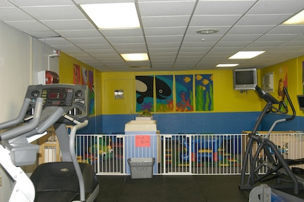 The new family fitness room at the Warhawk Fitness Center on Lackland Air Force Base, Texas, is designed to allow children to play while their parents or guardians exercise. (USAF photo by Mandi Cruz)                                