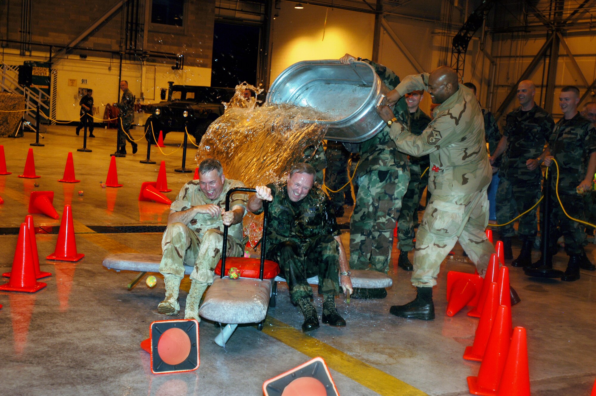 GRISSOM AIR RESERVE BASE, Ind. -- Brig. Gen. Dean Despinoy, 434th Air Refueling Wing commander, left, and Maj. Gen. Mark Pillar, mobilization augmentee, avoid a dousing by 434th ARW members as they make their way along the confusion course to the grog bowl during the Combat Dining in July 7. (U.S. Air Force photo/Tech. Sgt. Doug Hays)