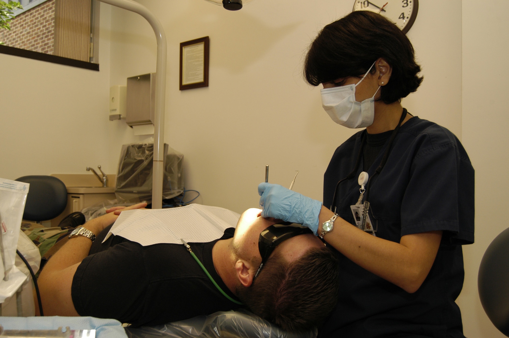 Maj. Elham Barani, 436th Aeromedical Dental Operations Squadron dentist, works on Senior Airman Mark Snead, 436th Services Squadron, July 11. Major Barani recently applied for a two-year Pediatric Residency.  (U.S. Air Force photo/Senior Airman James Bolinger)                                   