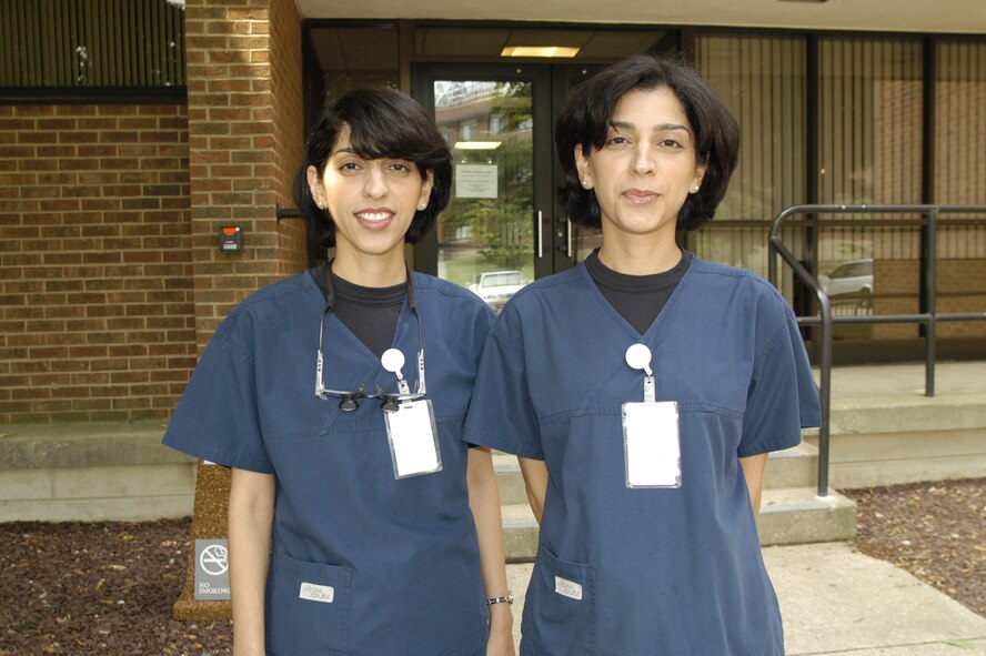 Maj. Arezoo Barani and her twin sister Maj. Elham Barani, both dentists with the 436th Aeromedical Dental Operations Squadron here, pose for a photograph in spirit of Dover Air Force Base's multicultural events. The twins are Iranian immigrants. (U.S. Air Force photo/Senior Airman James Bolinger)                                   