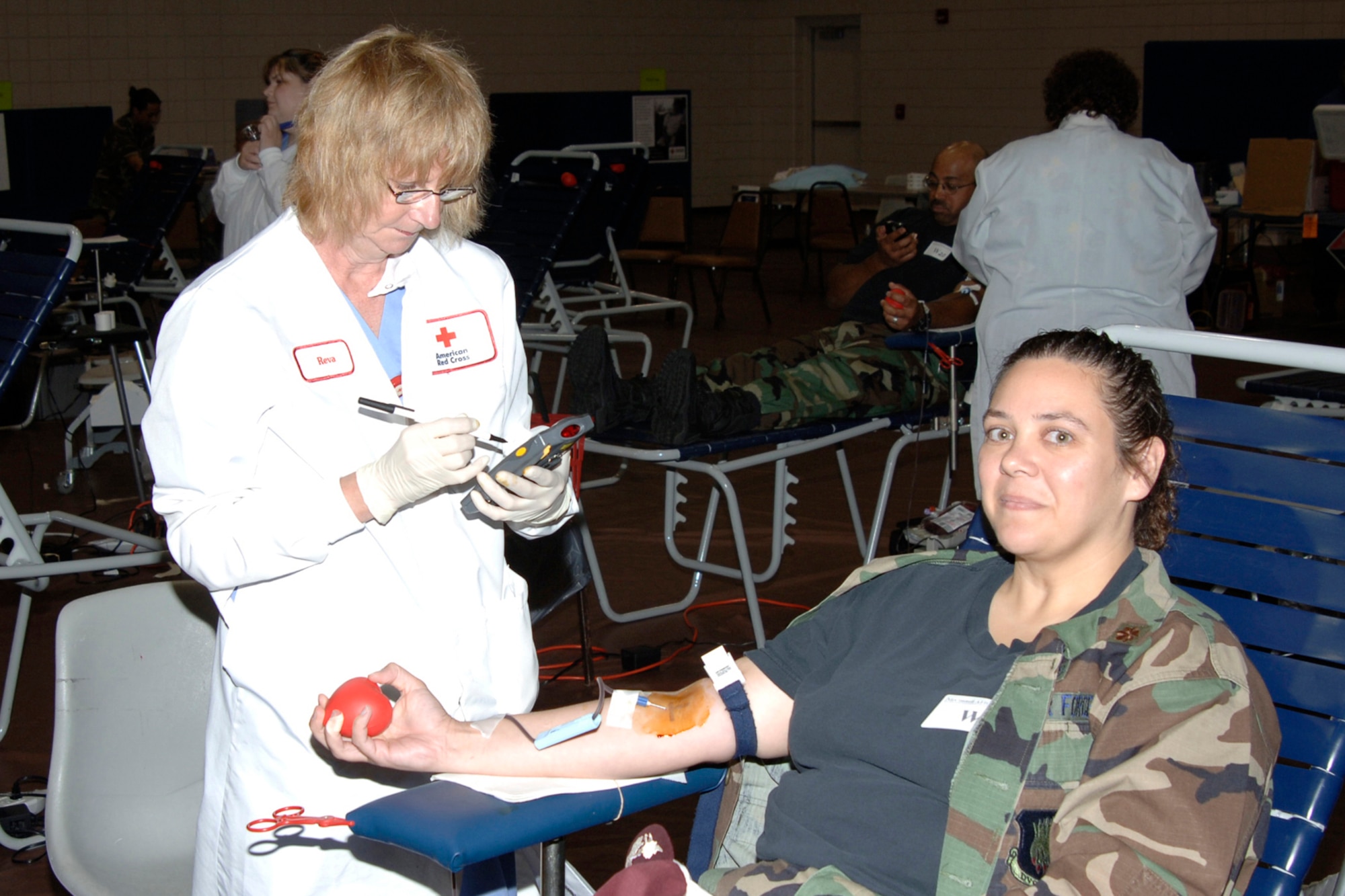 MCCONNELL AIR FORCE BASE, Kan. -- Reva Barkley, a phlebotomist from a local chapter of the American Red Cross, draws blood from Maj. Melissa Pammer, 22nd Medical Support Squadron, during a blood drive July 6 in the fitness center gymnasium. One hundred and fourteen Team McConnell members came out to donate blood and 33 of them were first-time donators. As a result of the turnout, the Red Cross collected 86 units of blood, which is roughly 86 pints. The next American Red Cross blood drive here is scheduled Sept. 14 from 9 a.m. to 2 p.m. in the fitness center gymnasium. (Photo by Airman 1st Class Roy Lynch)