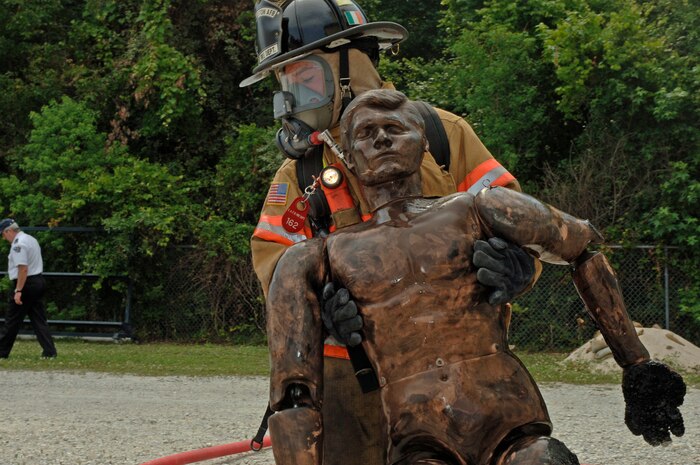 Airman Michael Dunnigan, 437th Civil Engineer Squadron, pulls a dummy from the fire during a training exercise May 23 at the Charleston AFB fire department training facility. (U.S. Air Force photo/Staff Sgt. April Quintanilla)