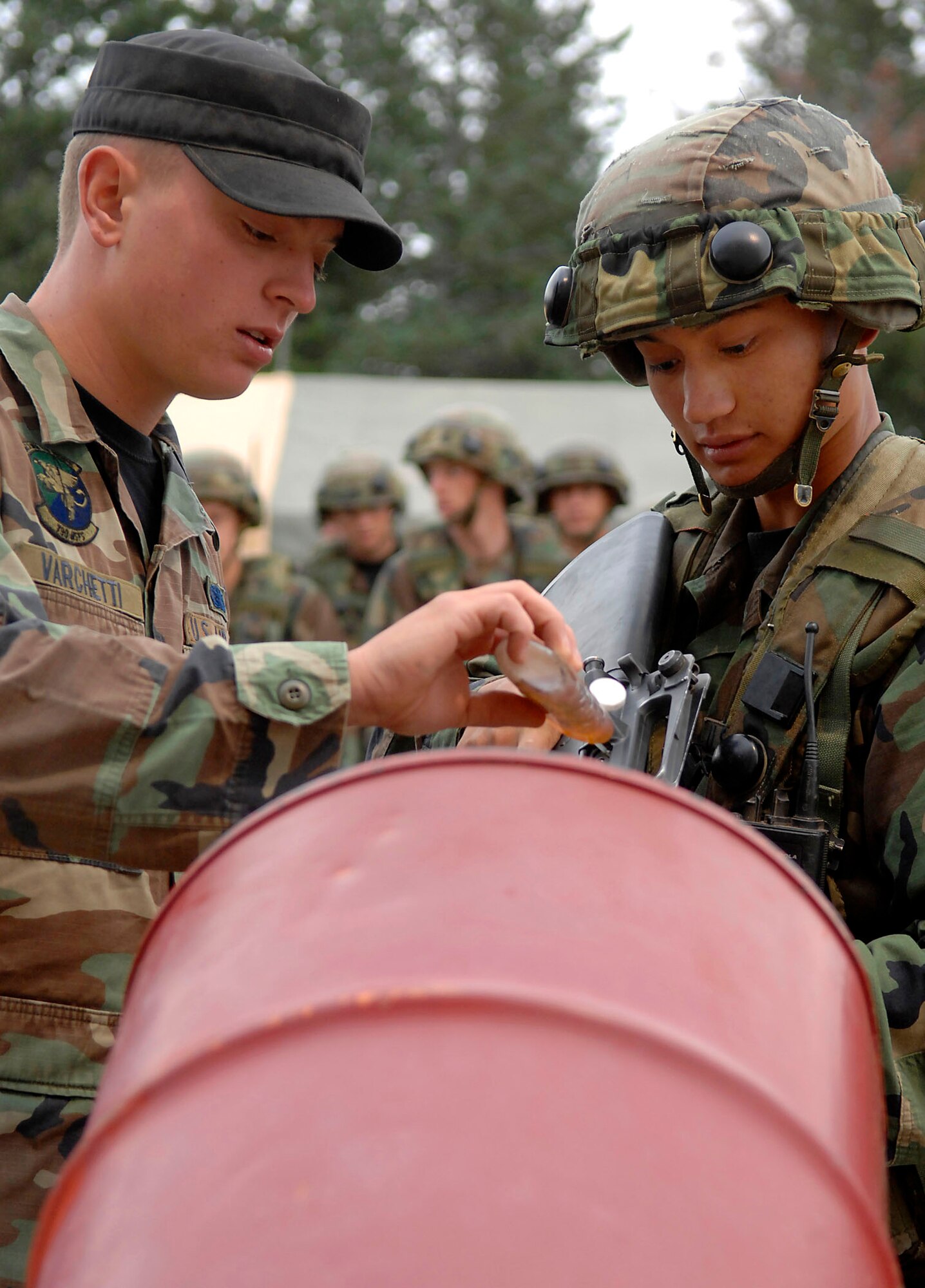 Senior Airman Ryan Varchetti (left) assists Cadet 3rd Class Daniel Tortuga with clearing and preparing his weapon during the Global Engagement course July 10 at the U.S. Air Force Academy in Colorado. The purpose of Global Engagement is to lay the foundation of attitudes, knowledge and skills necessary to lead, fight, and win in a dynamic and diverse global environment. Airman Varchetti is a security forces instructor from F.E. Warren Air Force Base, Wyo. (U.S. Air Force photo/Tech. Sgt. Larry A. Simmons)