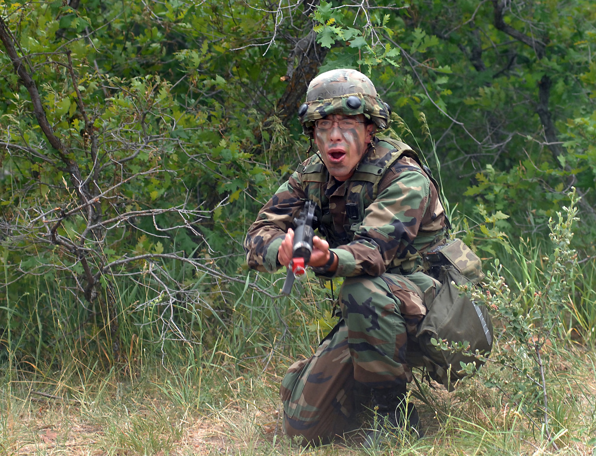 Cadet 3rd Class Luke Connolly yells instructions to his squadron while taking fire from opposition forces during the Global Engagement course July 10 at the Air Force Academy in Colorado. The purpose of Global Engagement is to lay the foundation of attitudes, knowledge and skills necessary to lead, fight, and win in a dynamic and diverse global environment. Sergeant Akers is a security forces instructor from Moody Air Force Base, Ga. (U.S. Air Force photo/Tech. Sgt. Larry A. Simmons) 
