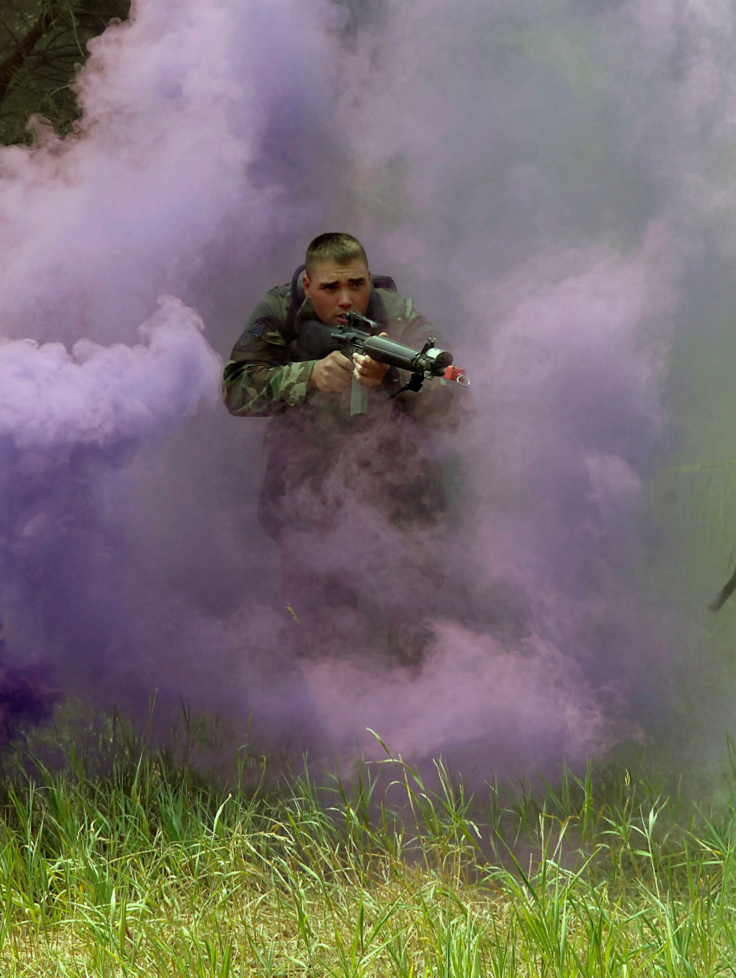 Staff Sgt. Brian Geike runs through cover smoke while attacking defensive firing positions manned by U.S. Air Force Academy cadets during the Global Engagement course July 11 at the Academy in Colorado. The purpose of Global Engagement is to lay the foundation of attitudes, knowledge and skills necessary to lead, fight, and win in a dynamic and diverse global environment. Sergeant Geike is a security forces instructor from Malmstrom Air Force Base, Mont. (U.S. Air Force photo/Tech. Sgt. Larry A. Simmons)

