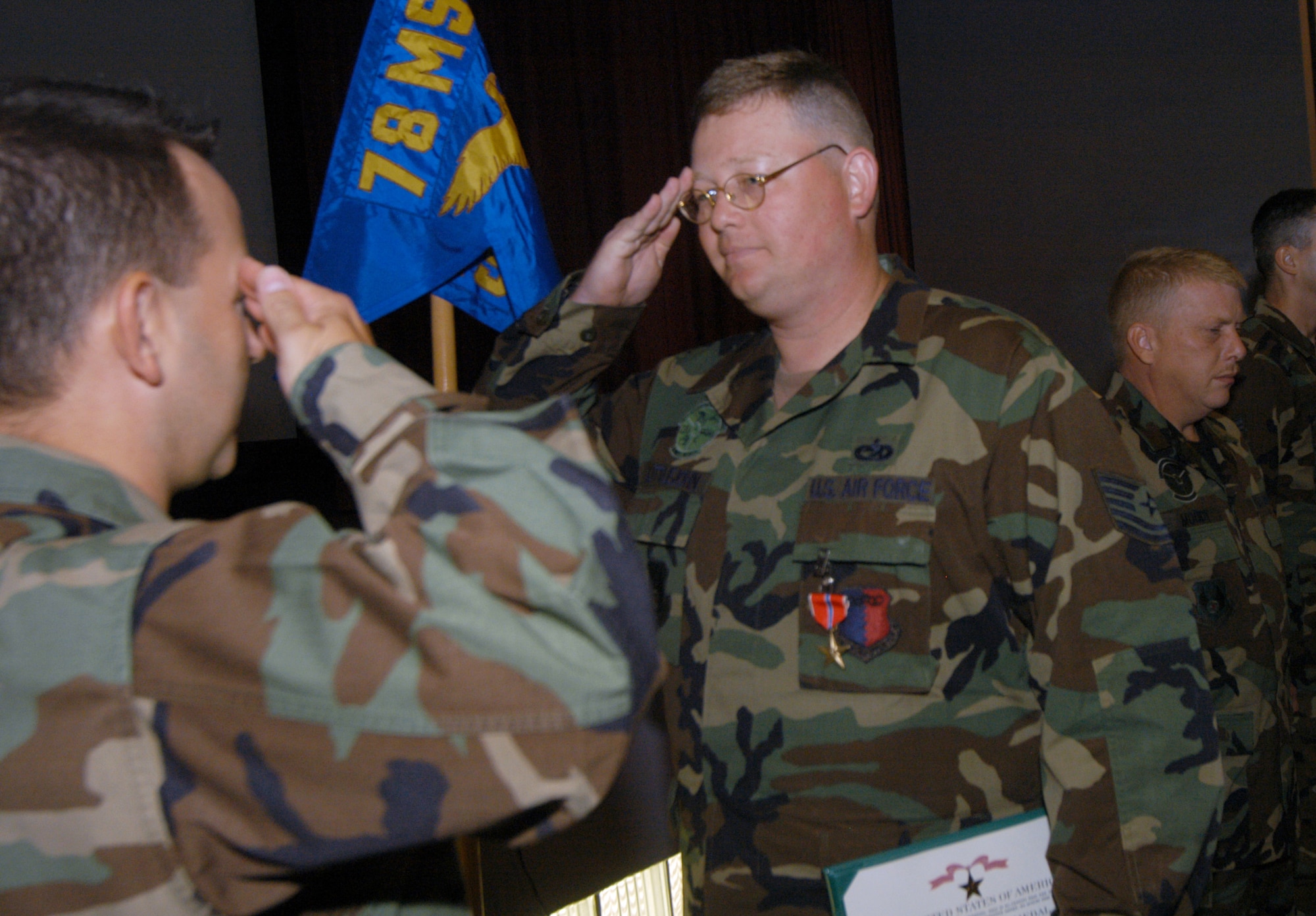 TSgt. Christopher Littlejohn salutes Major Scott Hall, 78th Logistics Readiness Squadron commander, after receiving his Bronze Star. U. S. Air Force photo by Sue Sapp     