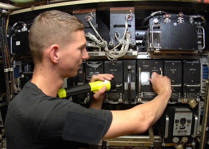 Airman 1st Class Randy Waite, 660th Aircraft Maintenance Squadron, tests the computer unit below the flight deck that controls various alarms throughout the flight deck and passenger compartment on a KC-10 aircraft. This computer is vital and controls alarms ranging anywhere from an engine fire to low cabin pressure. (U.S. Air Force photo/Laura Fentress)