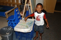 Reginald "R.J." Mann Jr., a 3-year-old in Playgroup, shows off his art work. The Children's Playgroup at Lackland Air Force Base, Texas, meets every Tuesday and Thursday at 9:30 a.m. R.J. is the son of Natasha and Senior Airman Reginald Mann of the Cryptologic Systems Group. (USAF photo by Mondo Flores)                               