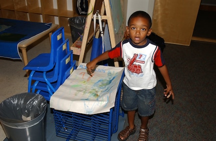 Reginald "R.J." Mann Jr., a 3-year-old in Playgroup, shows off his art work. The Children's Playgroup at Lackland Air Force Base, Texas, meets every Tuesday and Thursday at 9:30 a.m. R.J. is the son of Natasha and Senior Airman Reginald Mann of the Cryptologic Systems Group. (USAF photo by Mondo Flores)                               