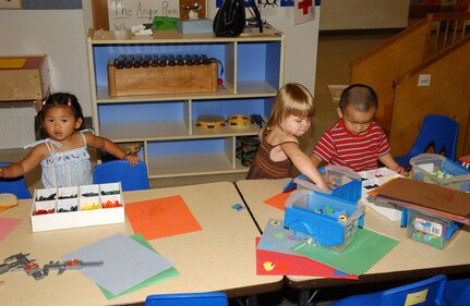 Neila Rae Mangiliman, left, prepares to color while Frankie Calnicean and A.J. Wong, all 2-year-olds, choose their favorite blocks to build with at Children's Playgroup on Lackland Air Force Base, Texas. Playgroup is held in Bldg. 8205. Neila is the daughter of Norilyn and Staff Sgt. Restie Mangiliman of the 59th Medical Operations Squadron. Frankie is the daughter of Karen and Capt. Michael Calnicean of the 59th Aerospace Medicine Squadron. A.J. is the son of Nancy and Capt. Aaron Wong of the 33rd Information Operations Squadron. (USAF photo by Mondo Flores)                               
